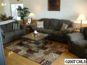9070 Meadow Vista Road Charlotte, NC 28213 - Photo 4 of 8 a living room with furniture and a chandelier