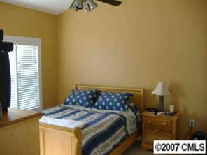 9070 Meadow Vista Road Charlotte, NC 28213 - Photo 5 of 8 a bedroom with a bed and cabinets