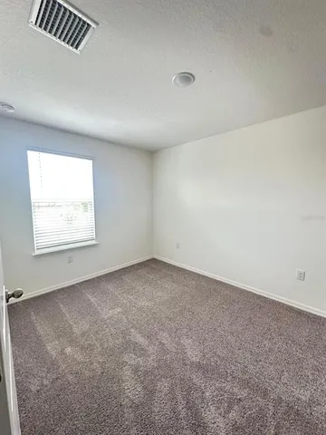 a view of storage and utility room with racks on the wall