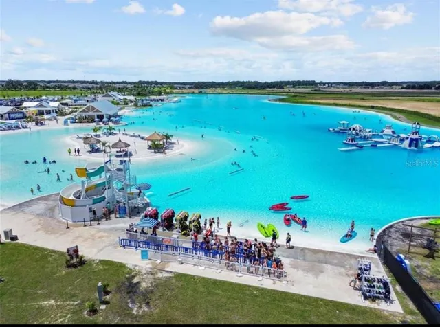 a view of a house with a garden and lake view