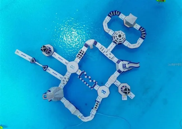 a view of a lake with a table and chairs