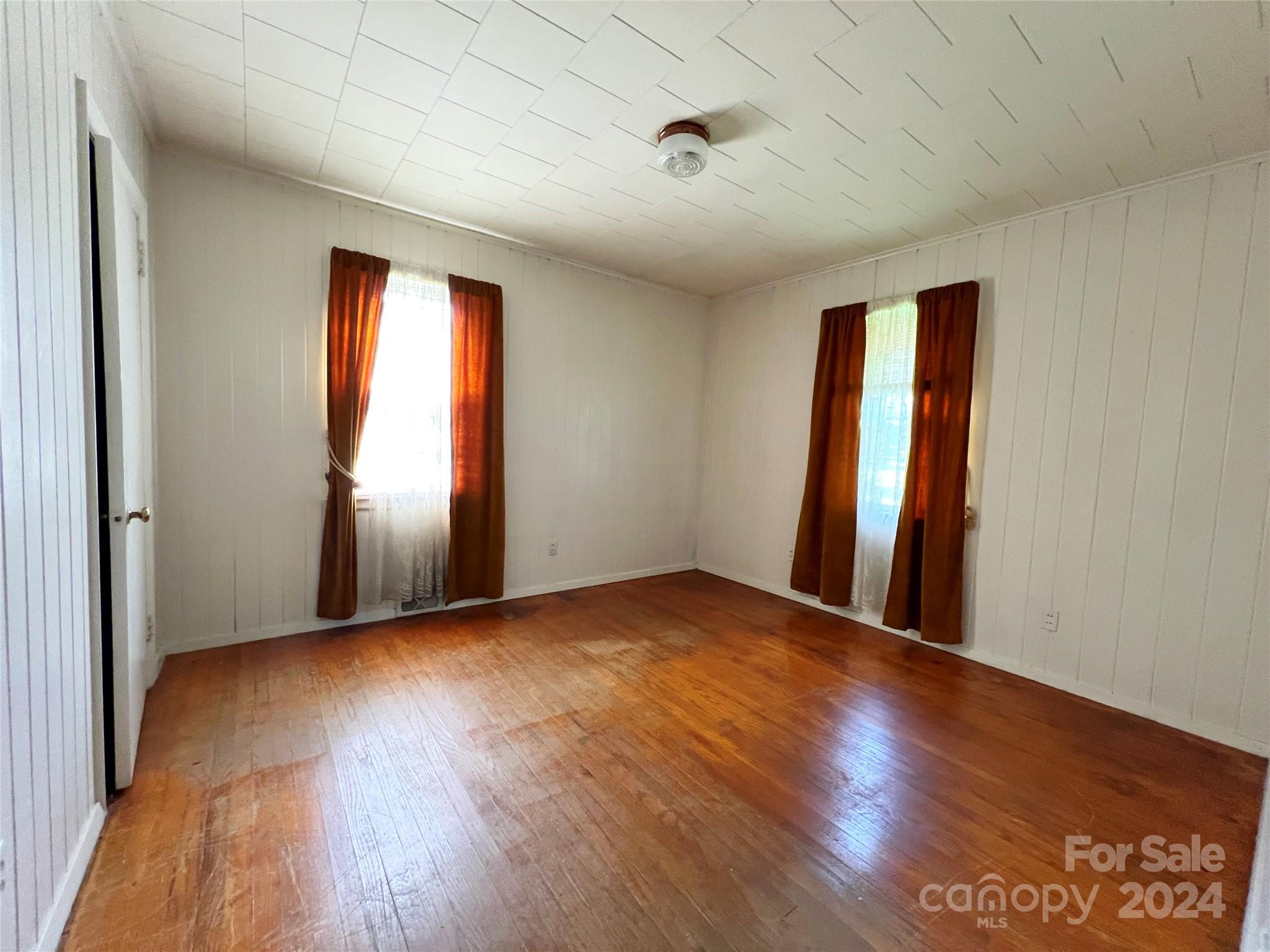 102 Steakhouse Road Morganton, NC 28655 - Photo 28 of 39 an empty room with wooden floor and windows