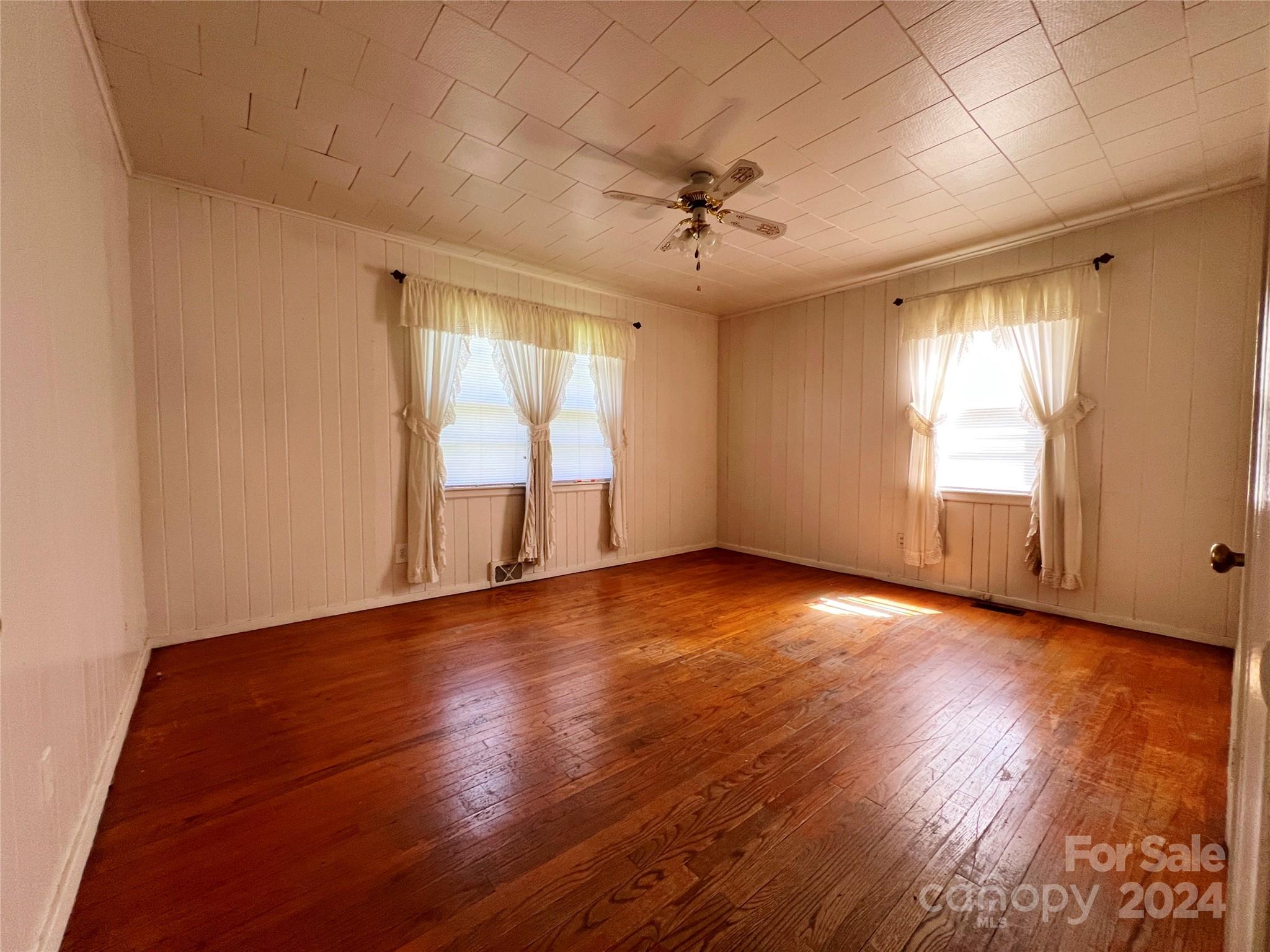 102 Steakhouse Road Morganton, NC 28655 - Photo 29 of 39 an empty room with wooden floor and windows