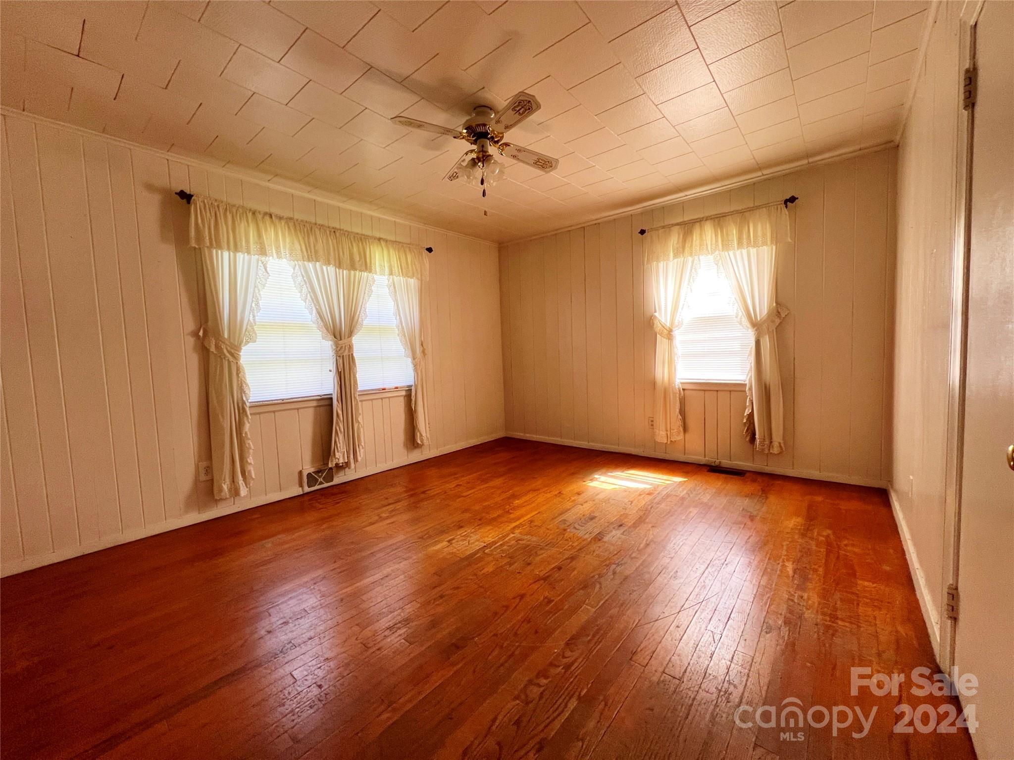 102 Steakhouse Road Morganton, NC 28655 - Photo 30 of 39 an empty room with wooden floor and windows