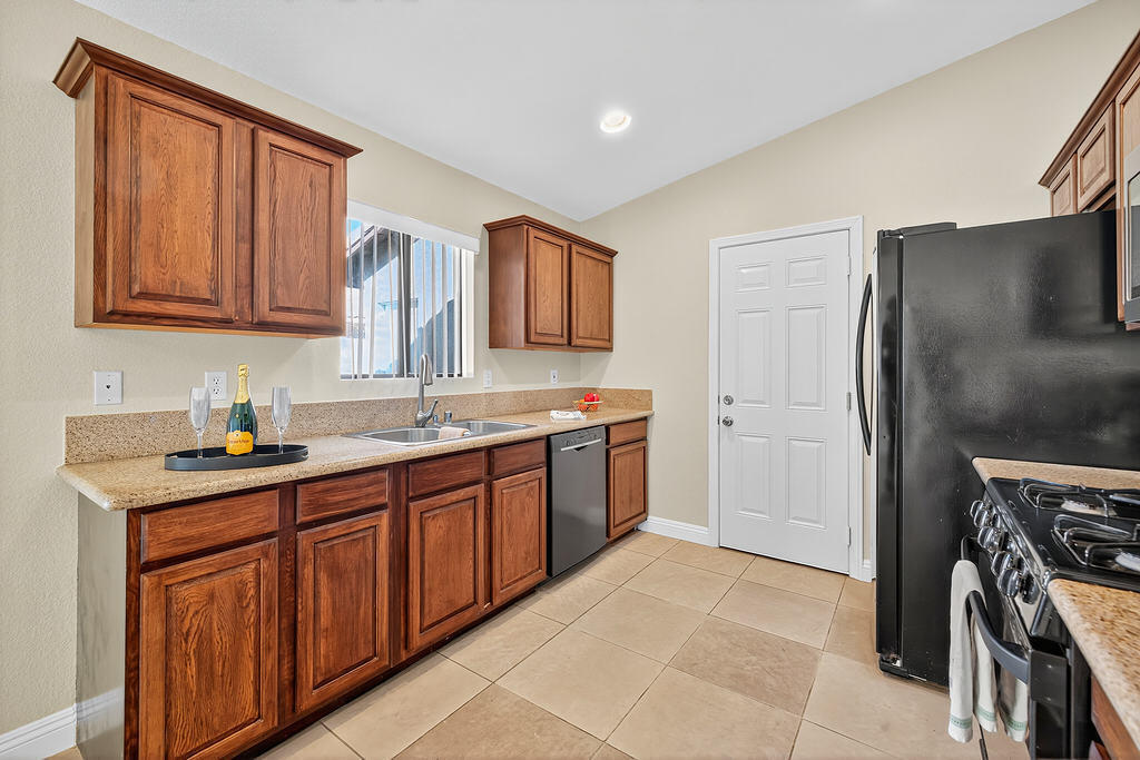 68615 Concepcion Road Cathedral City, CA 92234 - Photo 11 of 25 a kitchen with stainless steel appliances granite countertop a refrigerator and a sink