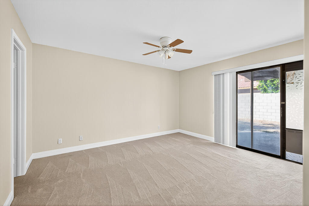 68615 Concepcion Road Cathedral City, CA 92234 - Photo 14 of 25 an empty room with windows and fan