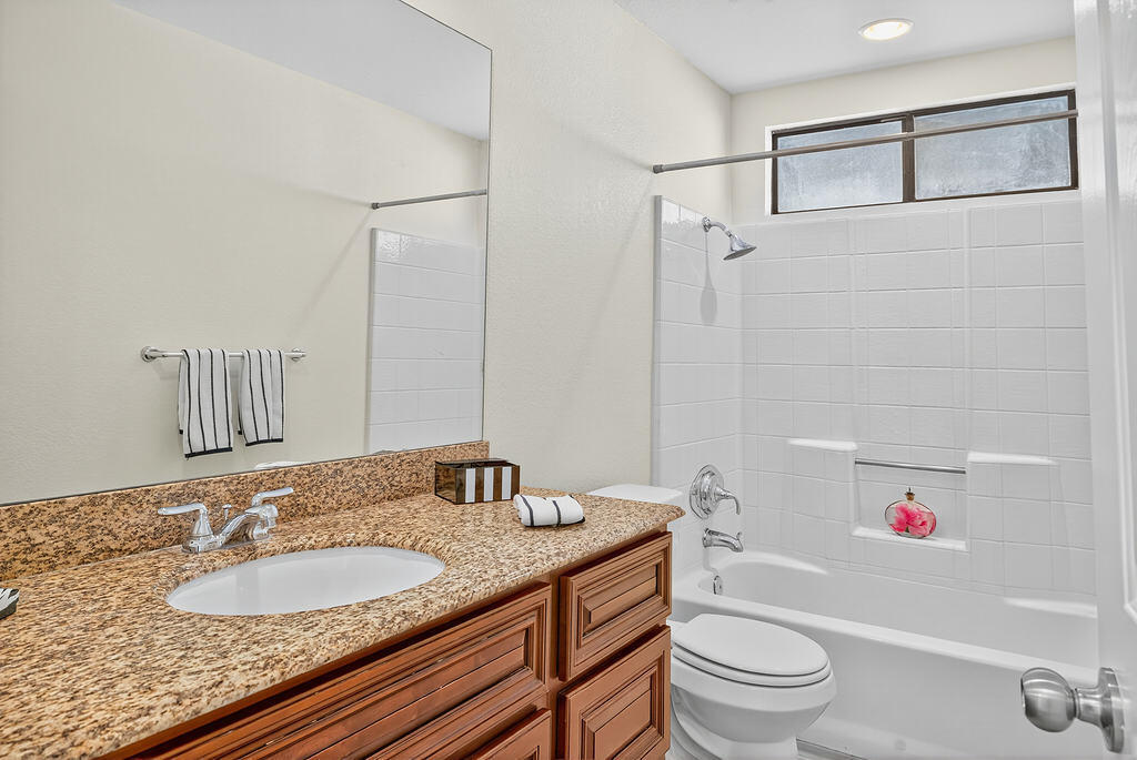 68615 Concepcion Road Cathedral City, CA 92234 - Photo 5 of 25 a bathroom with a granite countertop sink toilet mirror and shower