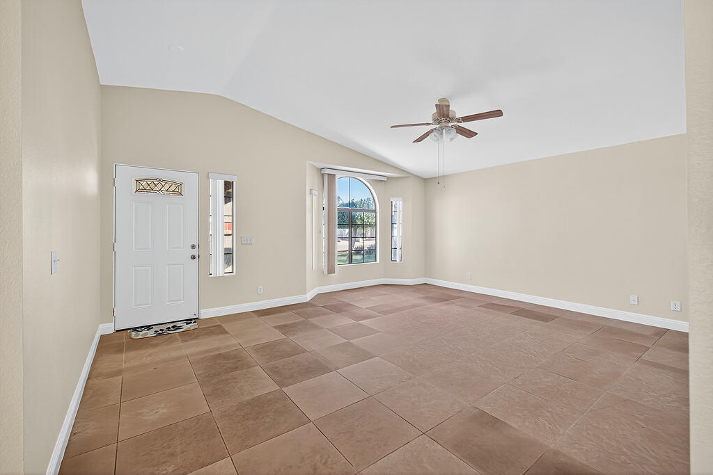 68615 Concepcion Road Cathedral City, CA 92234 - Photo 7 of 25 an empty room with a ceiling fan and a window