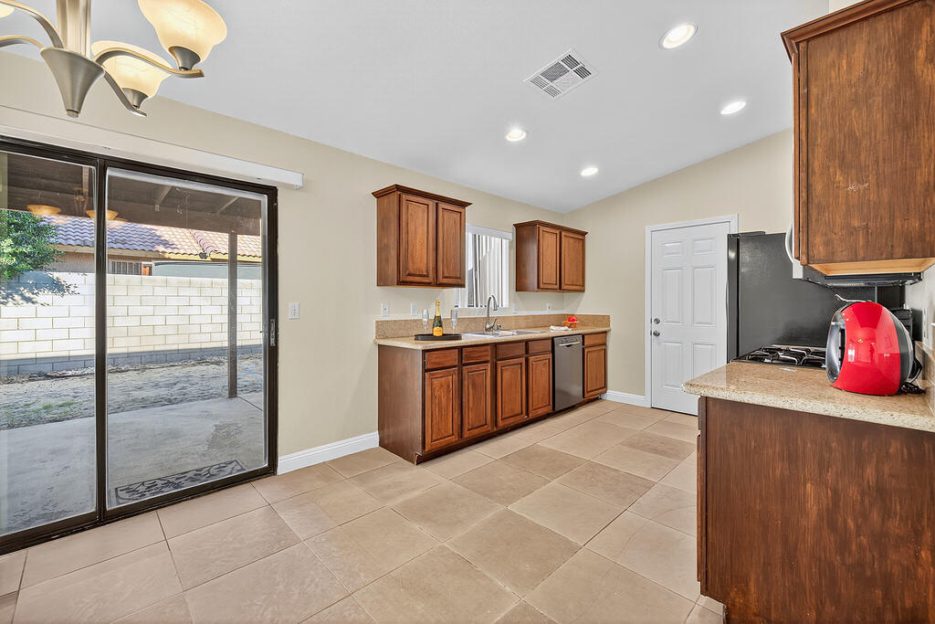 68615 Concepcion Road Cathedral City, CA 92234 - Photo 10 of 25 a kitchen with stainless steel appliances a sink stove and cabinets