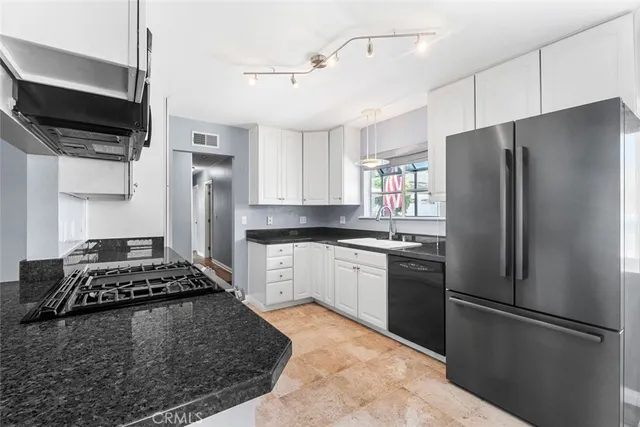 a kitchen with stainless steel appliances granite countertop a refrigerator stove and microwave