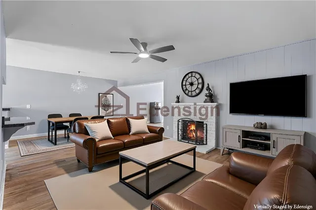 a living room with furniture a fireplace and a flat screen tv