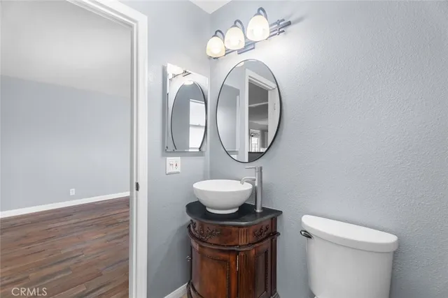 a bathroom with a toilet a sink and a mirror