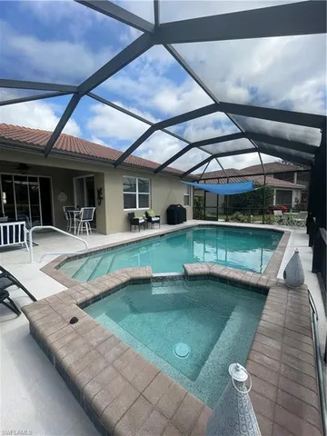 a view of a patio with swimming pool table and chairs