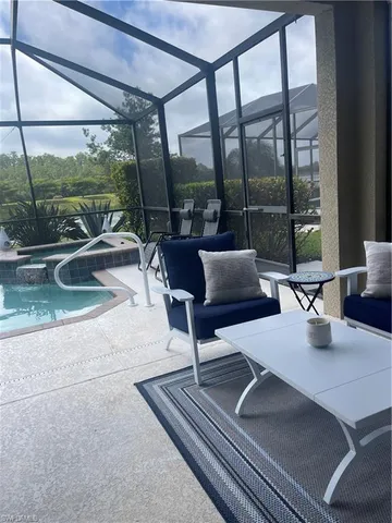 a building outdoor space with patio furniture and a potted plant