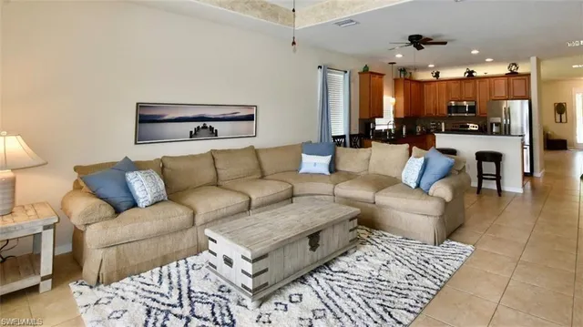 a living room with furniture and a chandelier