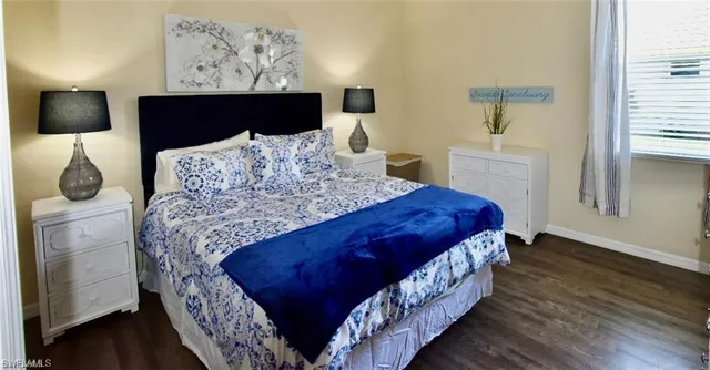 a bedroom with bed and window