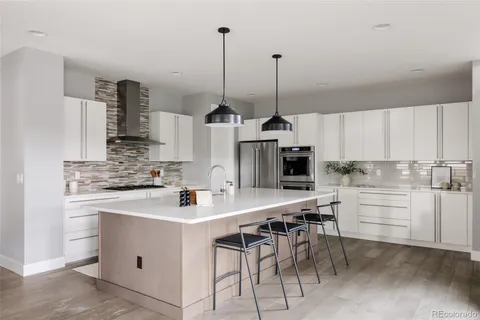 a kitchen with appliances cabinets and furniture