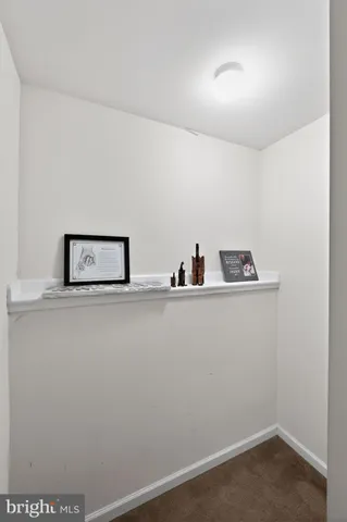 a kitchen with stainless steel appliances kitchen island granite countertop a refrigerator a stove a sink a dining table and chairs with wooden floor