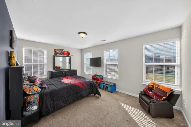a bedroom with furniture and a flat screen tv
