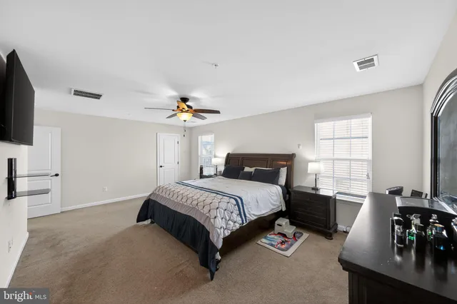 a bathroom with a granite countertop tub sink and mirror