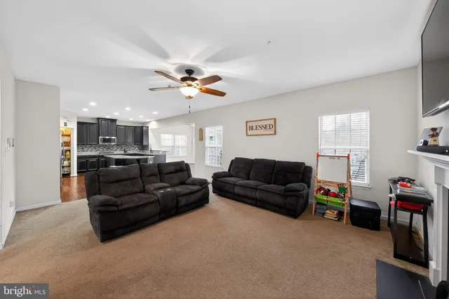 a living room with furniture and kitchen view