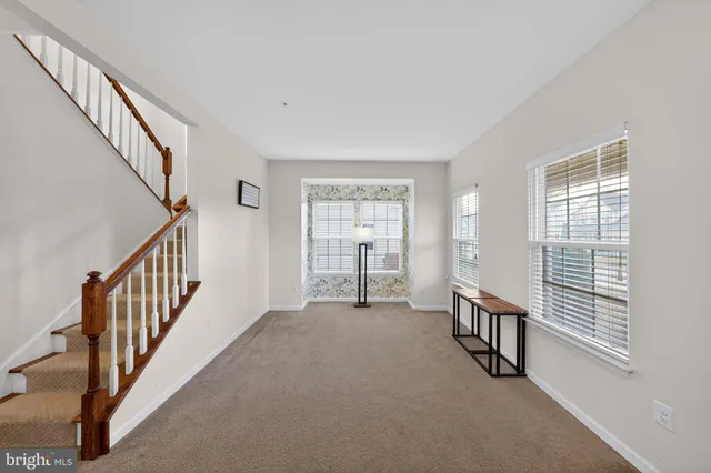 a view of an empty room with stairs