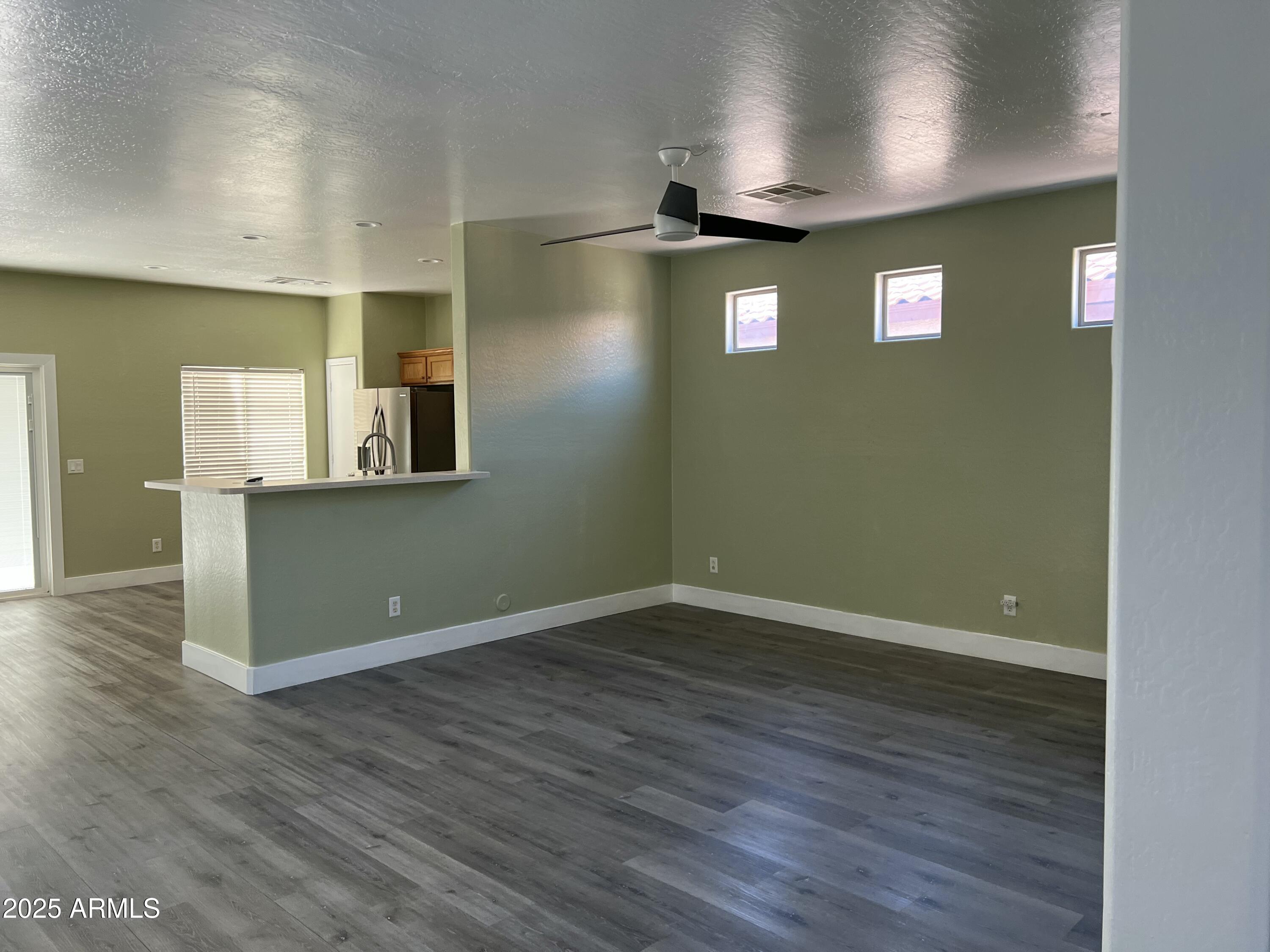 2679 East Chester Drive Chandler, AZ 85286 - Photo 11 of 30 an empty room with wooden floor and windows