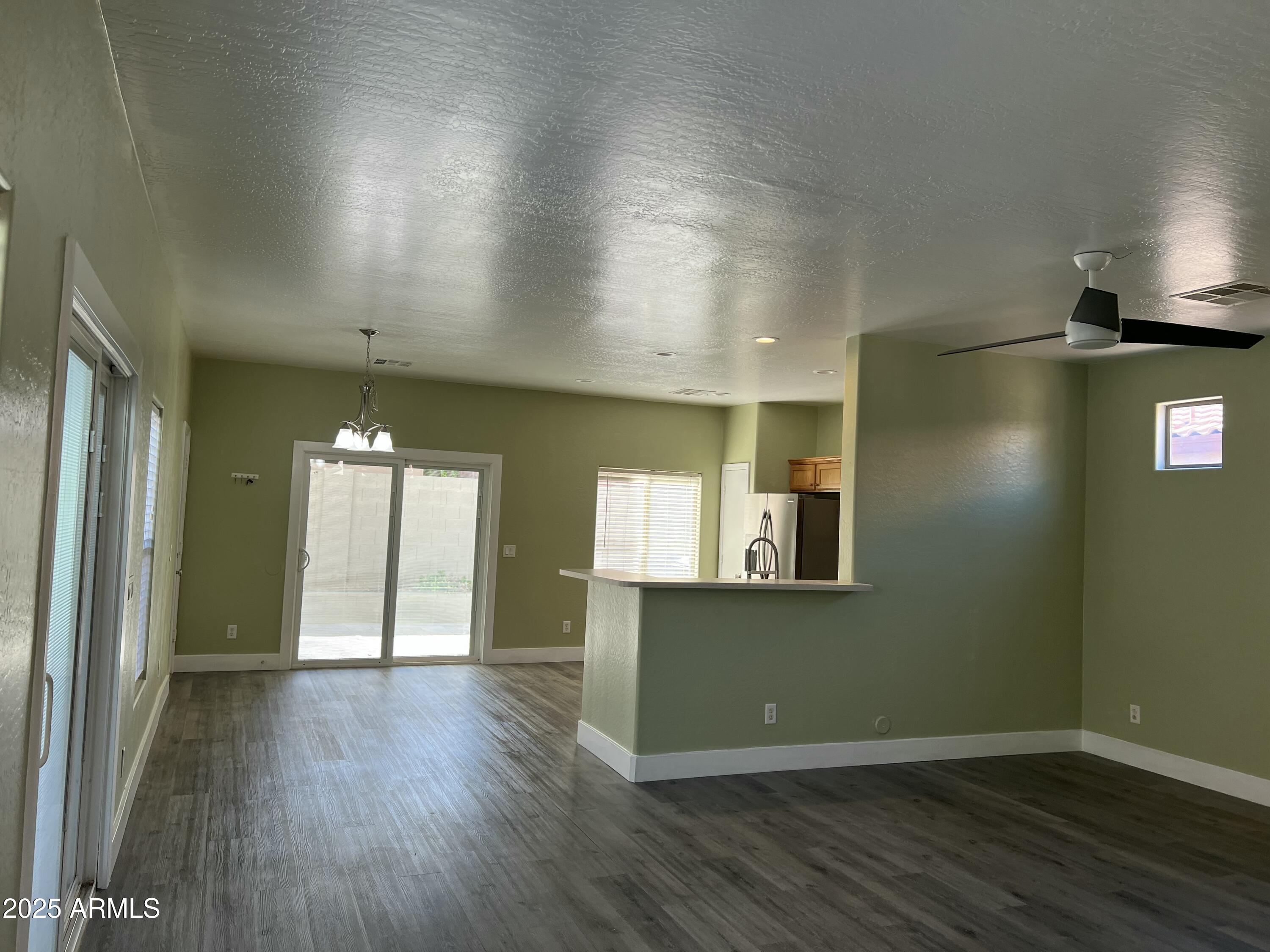 2679 East Chester Drive Chandler, AZ 85286 - Photo 12 of 30 an empty room with wooden floor and windows