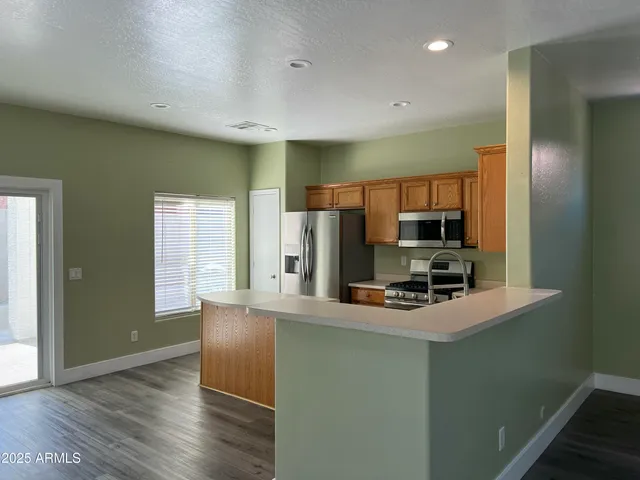 a kitchen with stainless steel appliances a microwave a stove and refrigerator