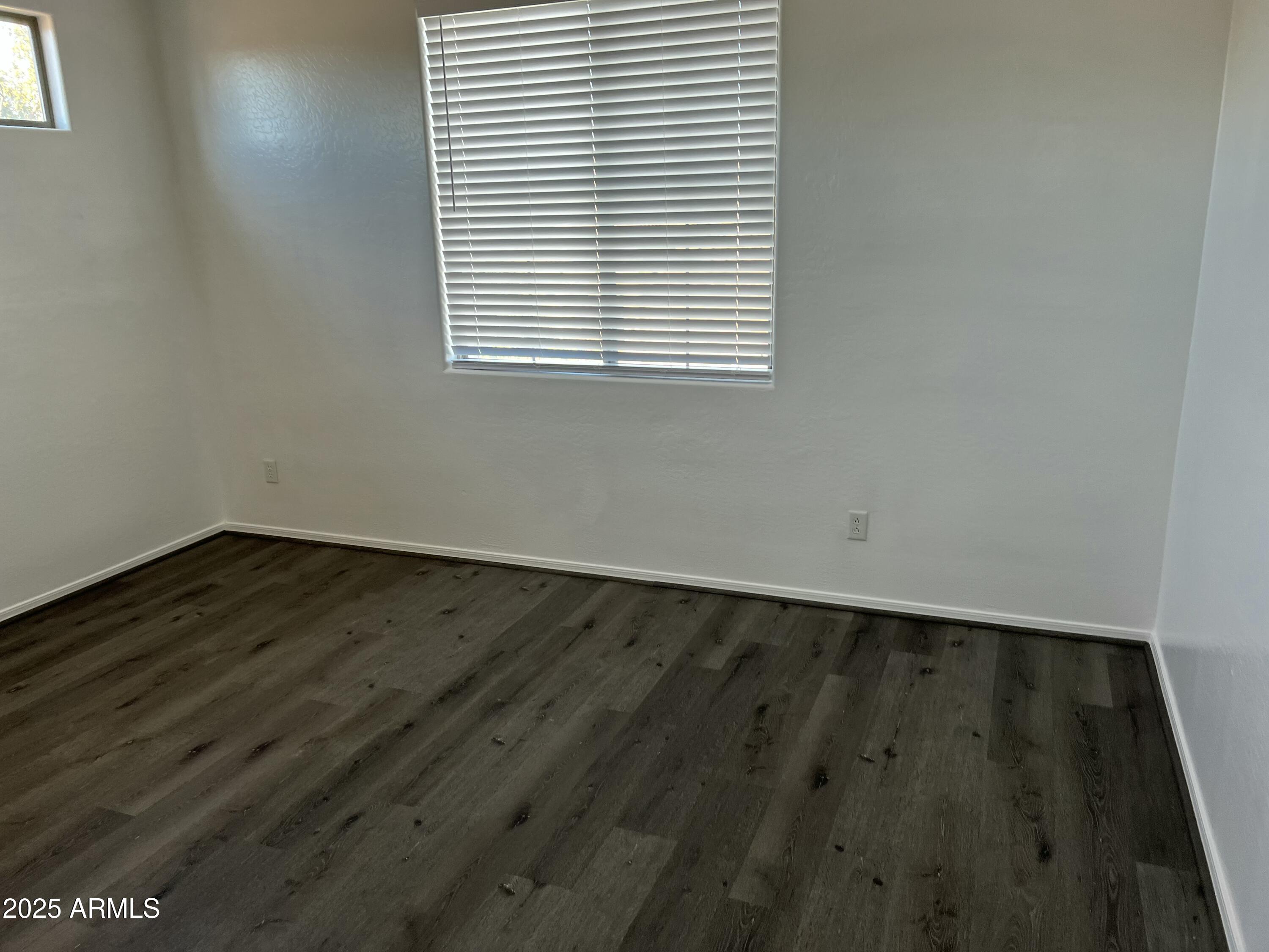 2679 East Chester Drive Chandler, AZ 85286 - Photo 20 of 30 an empty room with wooden floor and windows