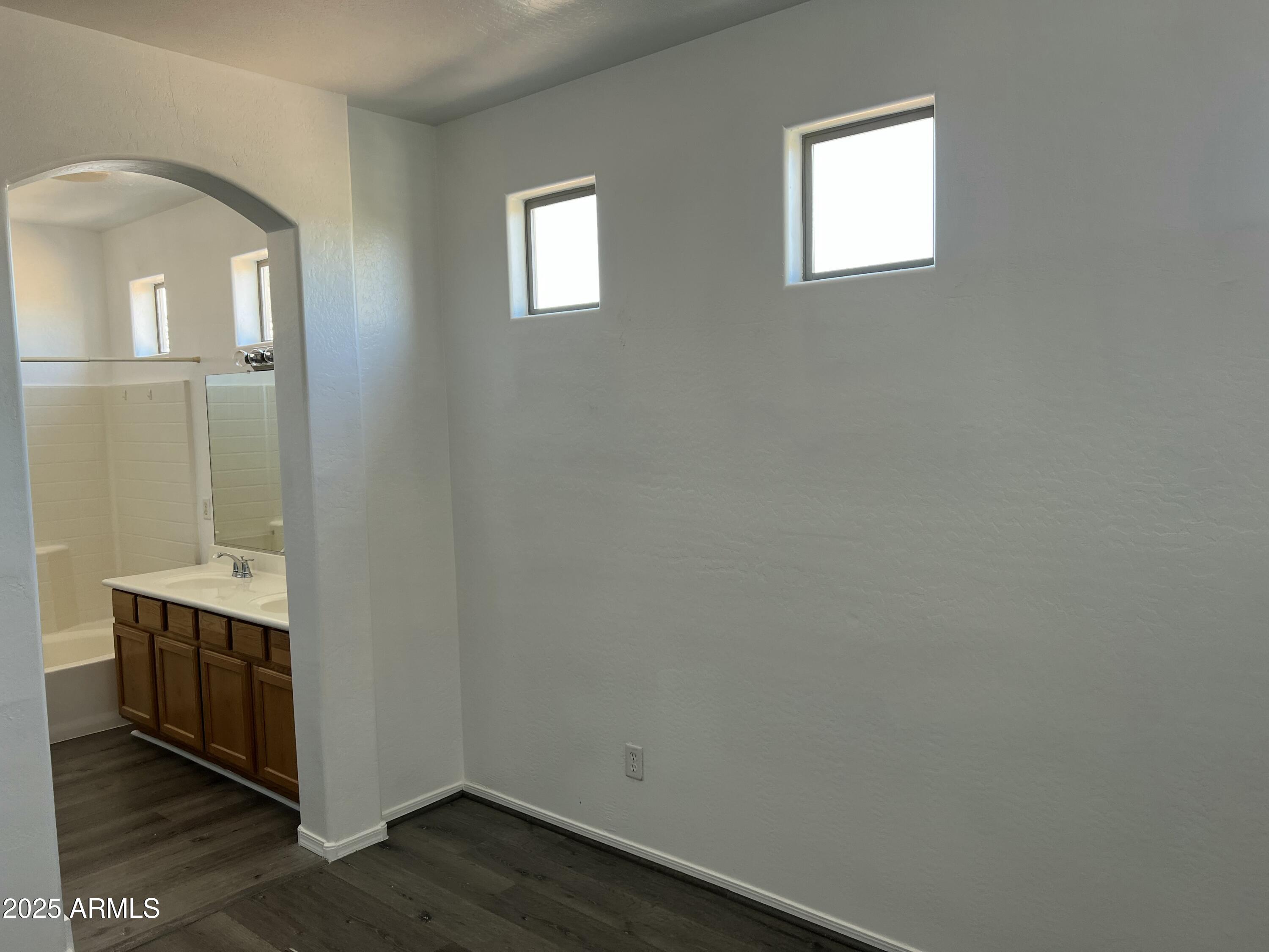 2679 East Chester Drive Chandler, AZ 85286 - Photo 21 of 30 a room with a chair and wooden floor