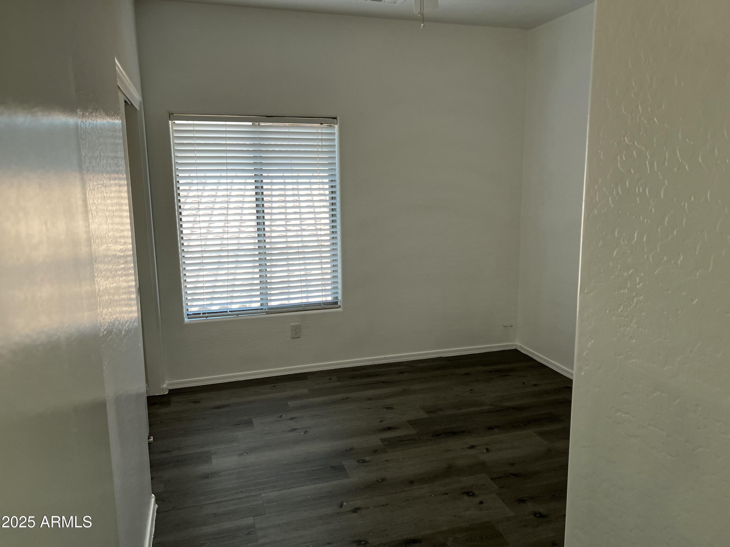 2679 East Chester Drive Chandler, AZ 85286 - Photo 25 of 30 a view of an empty room with wooden floor and a window
