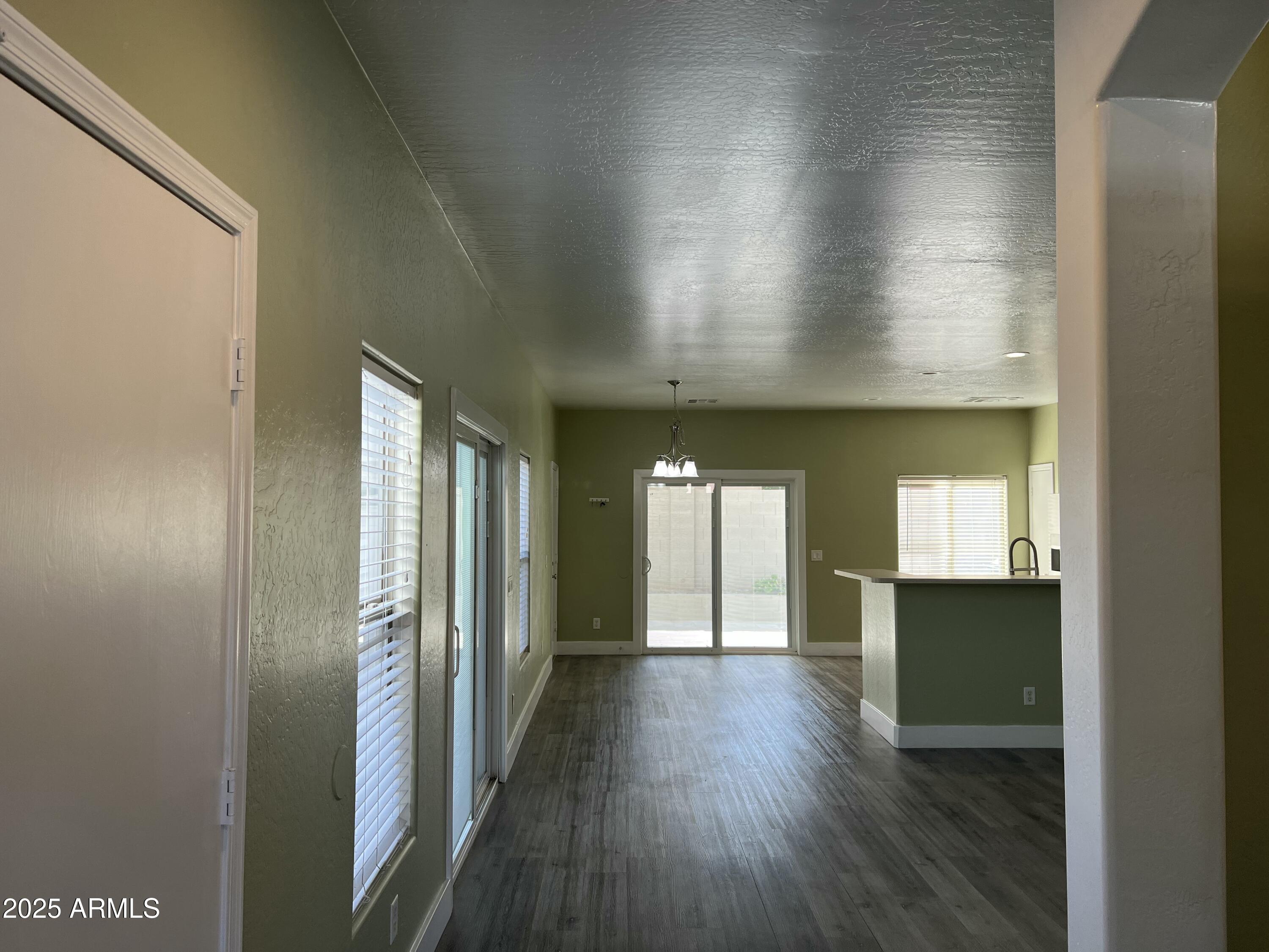 2679 East Chester Drive Chandler, AZ 85286 - Photo 10 of 30 a view of a hallway with wooden floor and a living room
