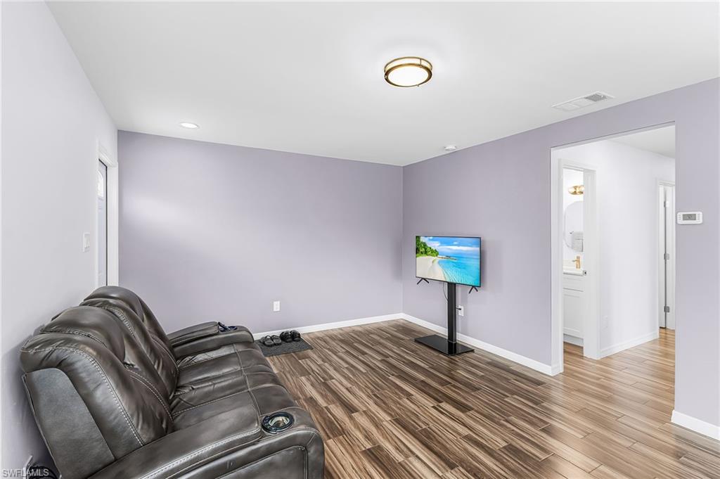 34 Hamlin Court Lehigh Acres, FL 33936 - Photo 10 of 29 a bedroom with bed and a night stand