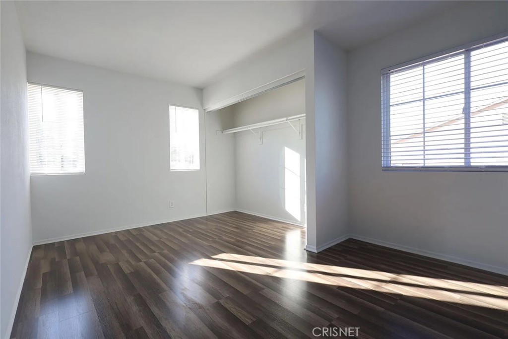 40046 Becky Lane Palmdale, CA 93551 - Photo 11 of 23 an empty room with wooden floor and windows