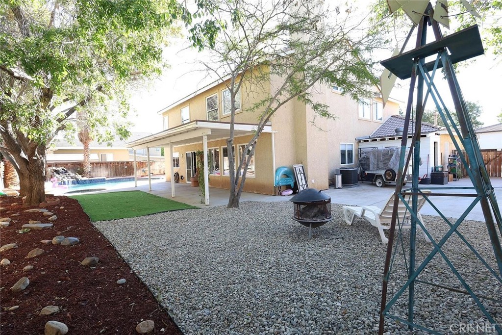 40046 Becky Lane Palmdale, CA 93551 - Photo 19 of 23 a view of a house with backyard and trees