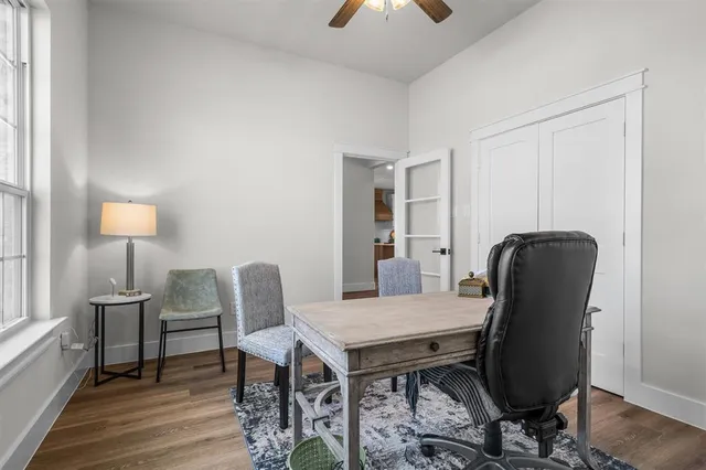 a view of a workspace with furniture and wooden floor