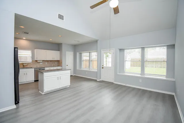 a large kitchen with kitchen island a sink dishwasher a stove and a refrigerator