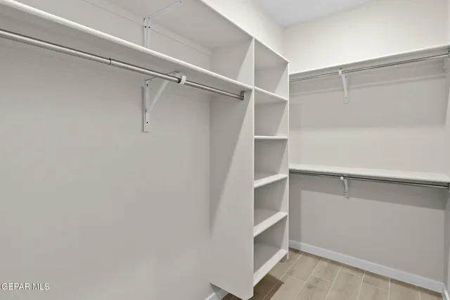 a view of walk in closet with empty racks