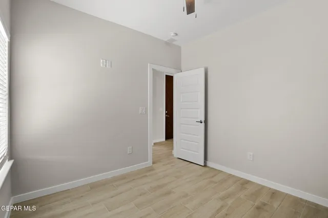 an empty room with wooden floor