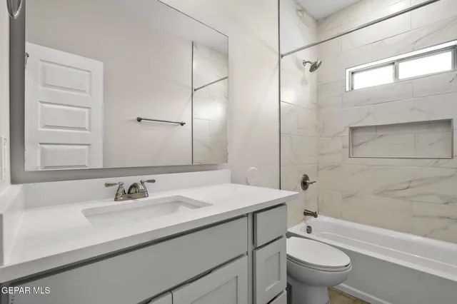 a bathroom with a sink toilet vanity and shower