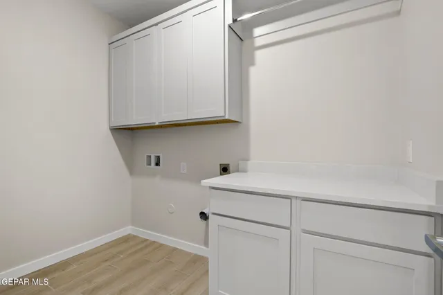 a room with a sink and cabinets