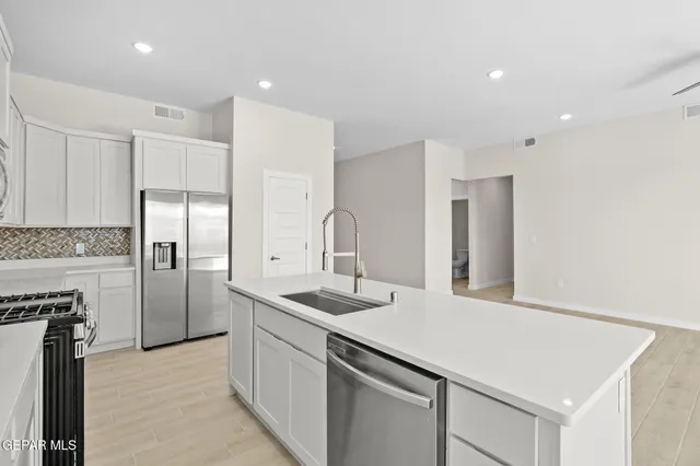 a kitchen with a sink and refrigerator