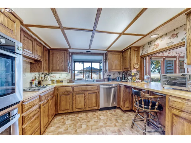 a kitchen with stainless steel appliances granite countertop a sink and cabinets