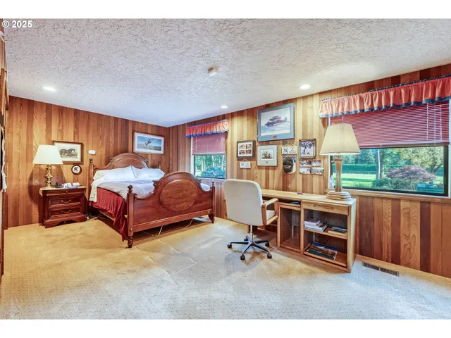 a bedroom with furniture and a large window