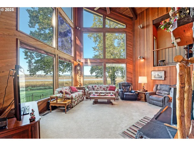 a living room with furniture and large windows