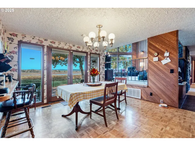 a view of a dining room with furniture and chandelier