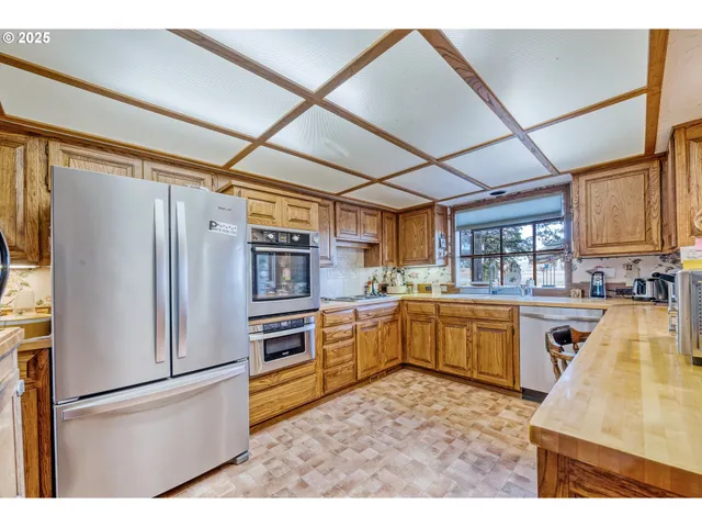 a kitchen with refrigerator and cabinets
