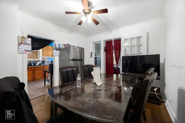 a kitchen with stainless steel appliances granite countertop a stove refrigerator and a dining table