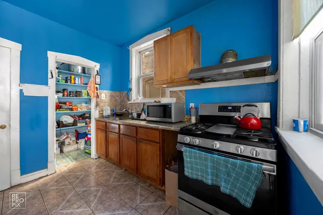 a kitchen with stainless steel appliances granite countertop a stove and cabinets